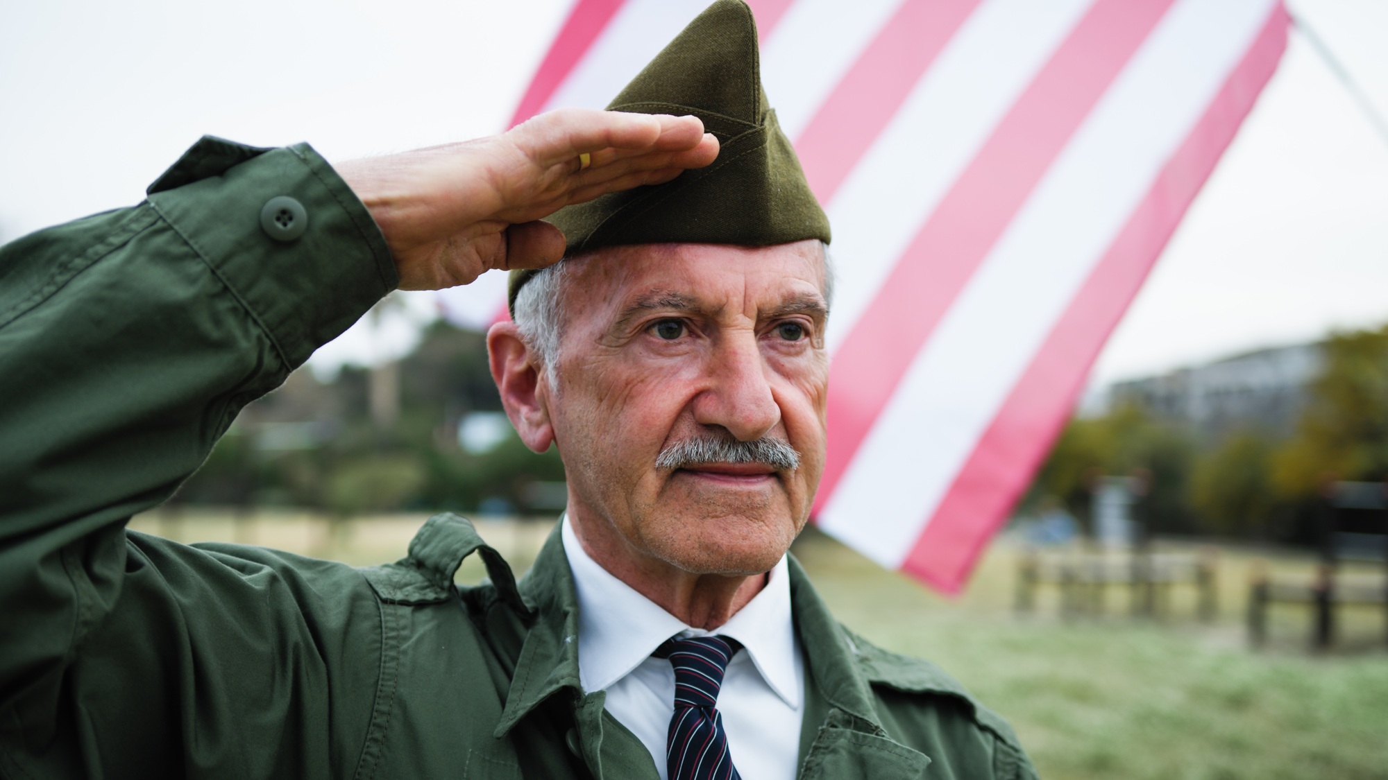 Veteran Salutes The American Flag On Memorial Day In The Cemetery Outdoor