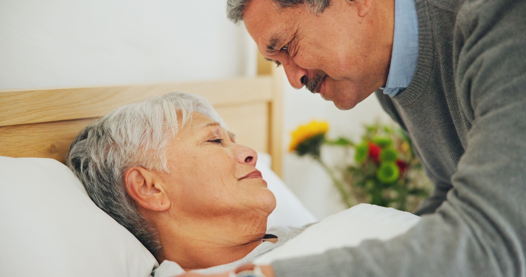 Woman, hospice and patient with sickness, husband and health issue with partner, sick or hand holdi